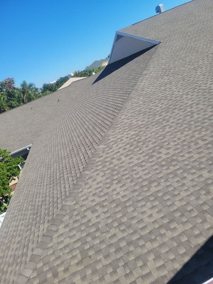 A roof with a brown shingled roof.