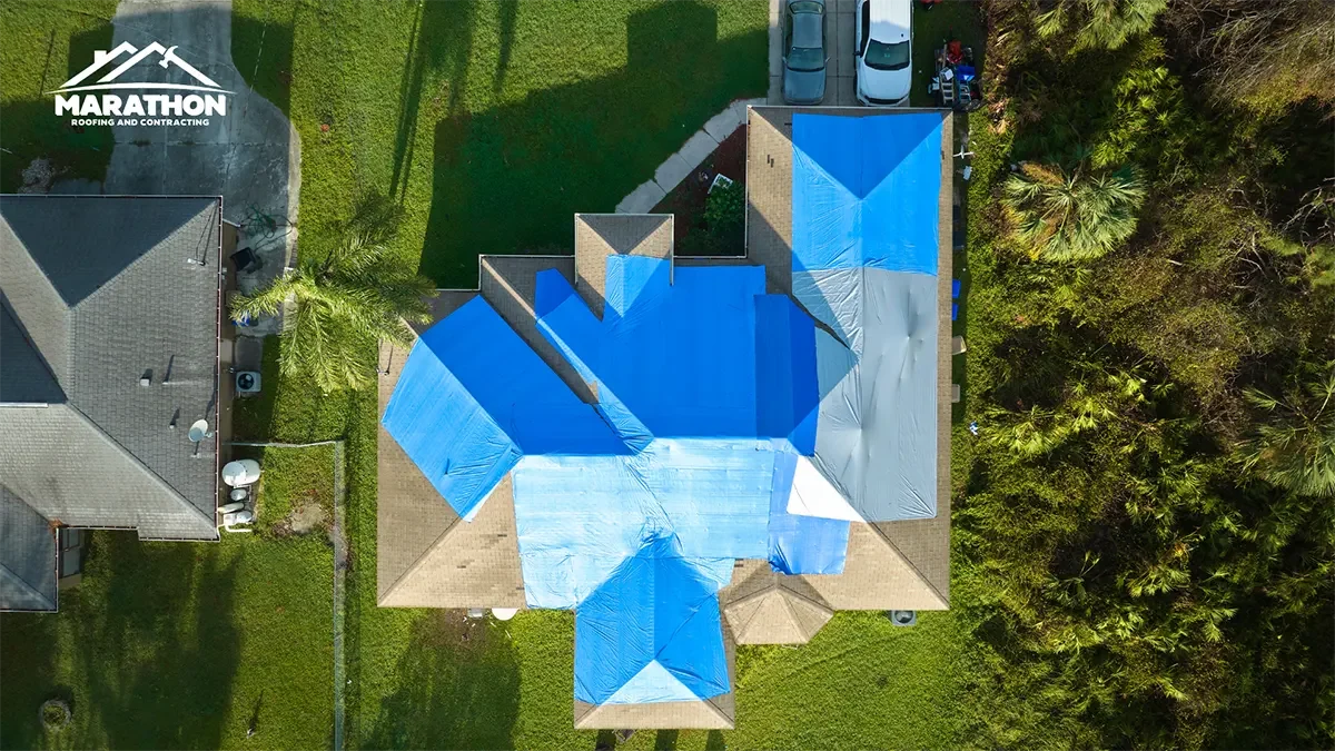 An aerial view of a blue roof on a house.